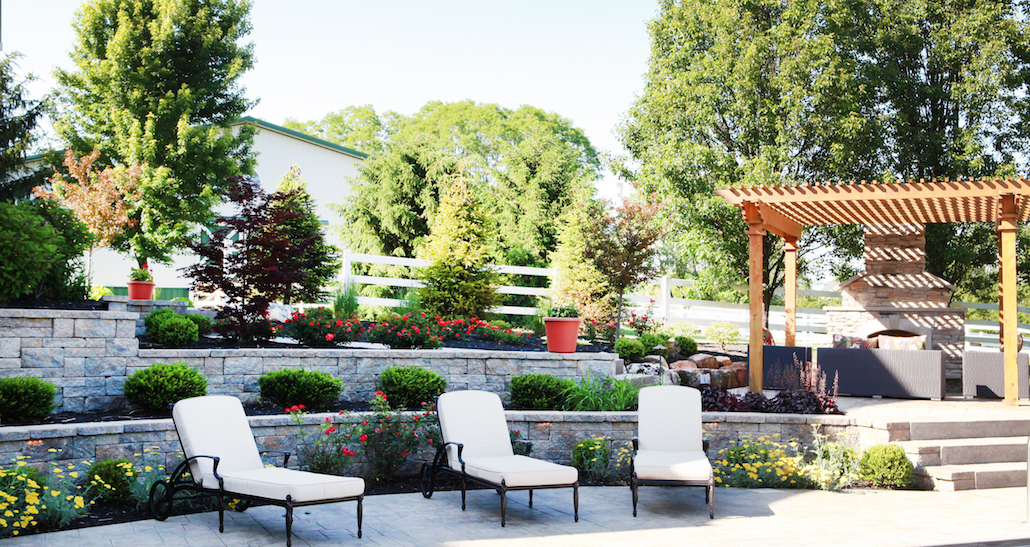 Pergola with lounge chairs on custom outdoor patio | Hittle Landscaping