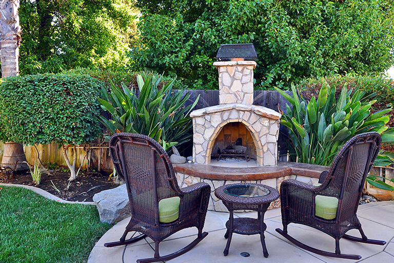 Rocking Chairs and Outdoor Fireplace | Return to Backyard Designs | Hittle Landscaping