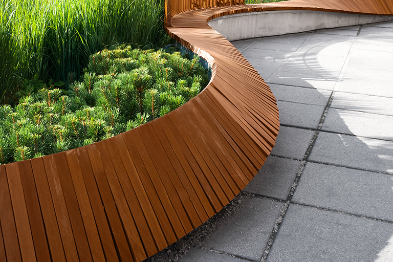 Curved wooden retaining wall | 3 Amazing Commercial Landscape Designs to Wow Customers | Hittle Landscaping