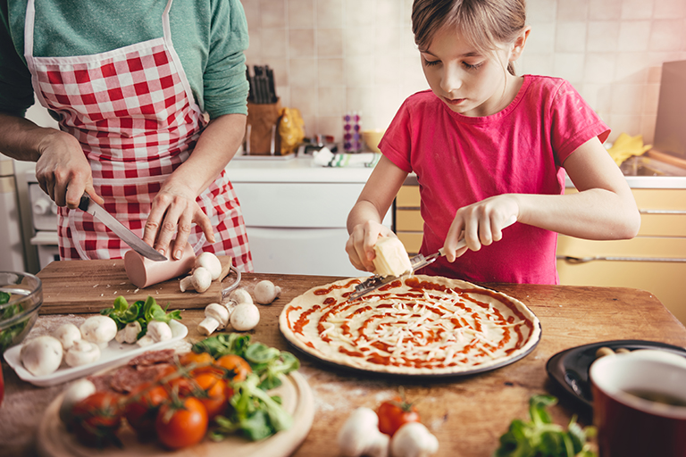 child making pizza | Plan a Backyard Garden for Cooking | Hittle Landscaping